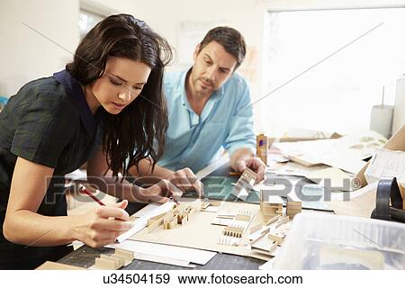 Stock Photo - Two Architects Making Models In Office Together. Fotosearch