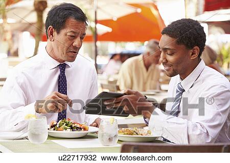 Two Businessmen Having Meeting In Outdoor Restaurant View Large Photo Image Stock Image - Two Businessmen Having Meeting In Outdoor Restaurant. Fotosearch