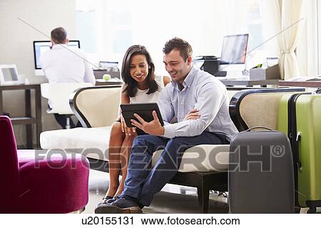 Two Businesspeople Having Meeting In Hotel Lobby View Large Photo Image Stock Image - Two Businesspeople Having Meeting In Hotel Lobby. Fotosearch