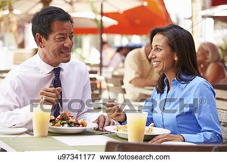 Two Businesspeople Having Meeting In Outdoor Restaurant View Large Photo Image Stock Photo - Two Businesspeople Having Meeting In Outdoor Restaurant. Fotosearch