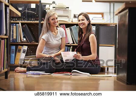 Two Businesswomen Sit On Office Floor With Digital Tablet View Large Photo Image Stock Image - Two Businesswomen Sit On Office Floor With Digital Tablet. Fotosearch