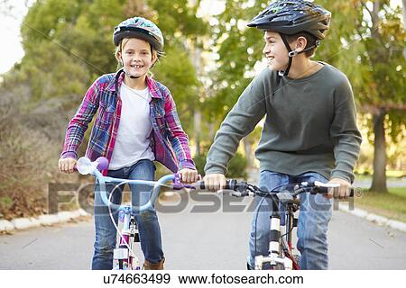 Stock Photo - Two Children On Cycle Ride In Countryside. Fotosearch