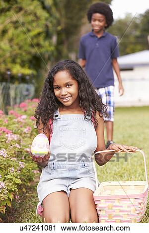 Two Children On Easter Egg Hunt In Garden View Large Photo Image Stock Image - Two Children On Easter Egg Hunt In Garden. Fotosearch