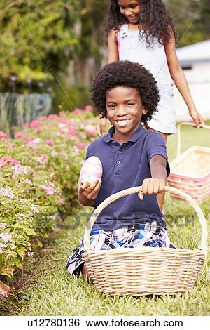 Two Children On Easter Egg Hunt In Garden View Large Photo Image Stock Photograph - Two Children On Easter Egg Hunt In Garden. Fotosearch