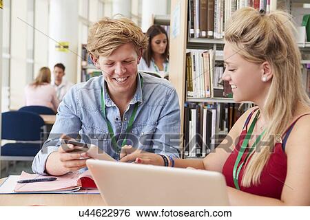 Stock Photograph - Two College Students Studying In Library Together. Fotosearch
