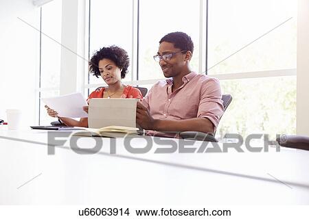 Picture - Two Creatives With Digital Tablet Working In Design Studio. Fotosearch