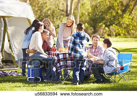 Picture - Two Families Enjoying Camping Holiday In Countryside. Fotosearch