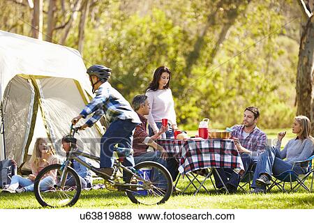 Stock Photo - Two Families Enjoying Camping Holiday In Countryside. Fotosearch