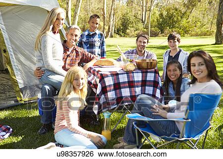 Stock Photograph - Two Families Enjoying Camping Holiday In Countryside. Fotosearch