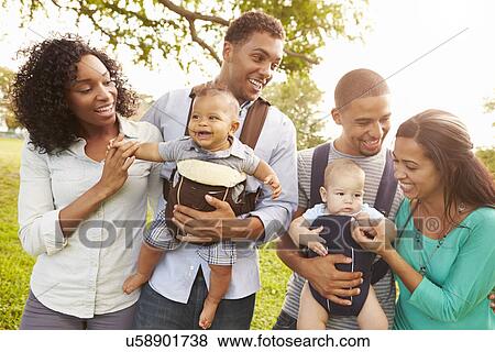 Two Families With Baby Carriers Walking In Park View Large Photo Image Stock Photo - Two Families With Baby Carriers Walking In Park. Fotosearch