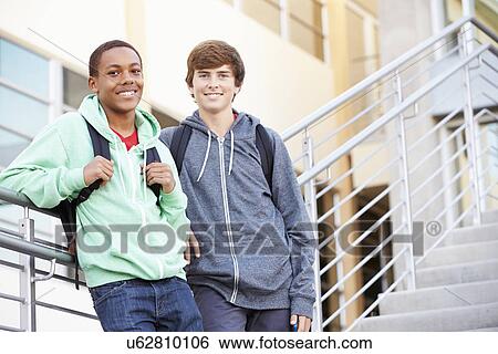 Stock Photograph - Two Male High School Students Standing Outside Building. Fotosearch