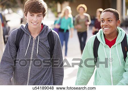 Stock Photo - Two Male Students Walking To High School. Fotosearch