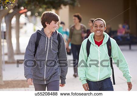 Stock Photo - Two Male Students Walking To High School. Fotosearch