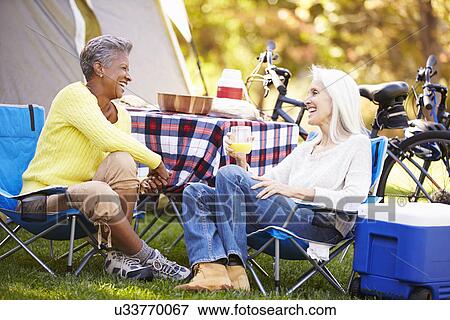 Two Mature Women Relaxing On Camping Holiday View Large Photo Image Stock Photo - Two Mature Women Relaxing On Camping Holiday. Fotosearch