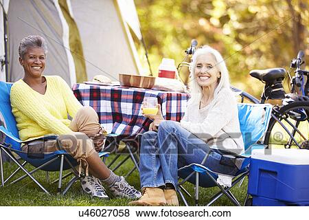 Two Mature Women Relaxing On Camping Holiday View Large Photo Image Stock Photo - Two Mature Women Relaxing On Camping Holiday. Fotosearch