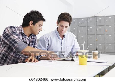 Stock Photograph - Two Men Working Together In Design Studio. Fotosearch
