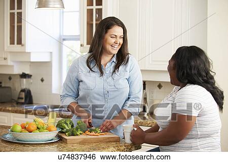 Two Overweight Women On Diet Preparing Vegetables in Kitchen View Large Photo Image Stock Photograph - Two Overweight Women On Diet Preparing Vegetables in Kitchen. Fotosearch