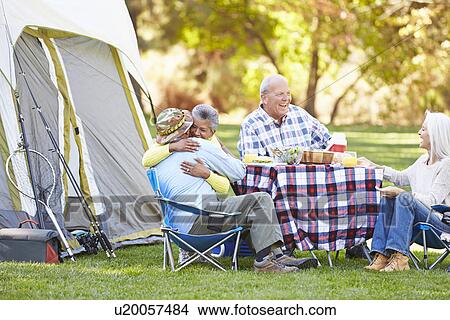 Two Senior Couples Enjoying Camping Holiday In Countryside View Large Photo Image Picture - Two Senior Couples Enjoying Camping Holiday In Countryside. Fotosearch
