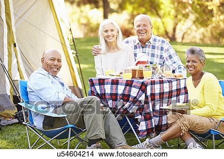 Two Senior Couples Enjoying Camping Holiday In Countryside View Large Photo Image Picture - Two Senior Couples Enjoying Camping Holiday In Countryside. Fotosearch