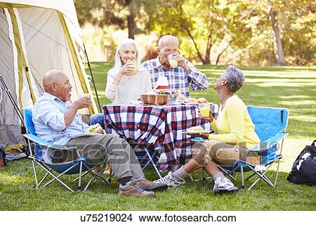 Two Senior Couples Enjoying Camping Holiday In Countryside View Large Photo Image Picture - Two Senior Couples Enjoying Camping Holiday In Countryside. Fotosearch
