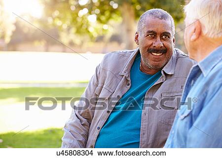 Picture - Two Senior Men Talking Outdoors Together. Fotosearch