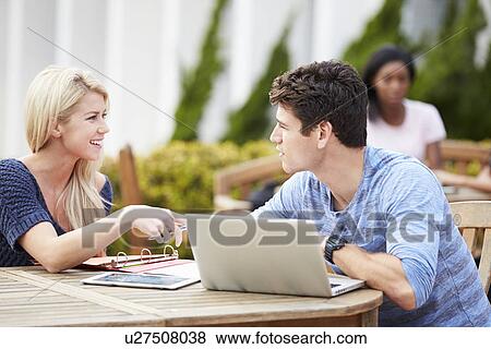 Stock Photo - Two University Students Working On Project Outdoors Together. Fotosearch
