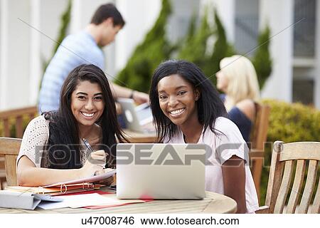 Two University Students Working On Project Outdoors Together View Large Photo Image Stock Photograph - Two University Students Working On Project Outdoors Together. Fotosearch