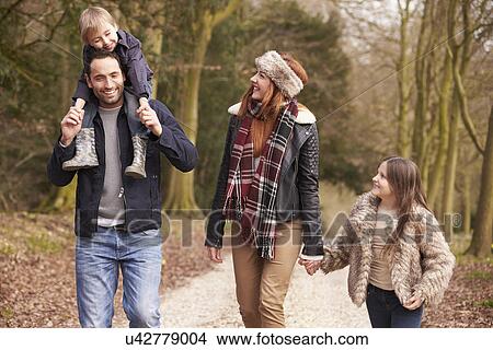 Picture - Two Women Cycling Through Urban Park Together. Fotosearch