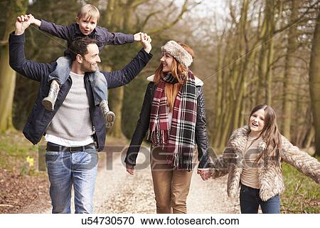 Stock Image - Two Women Cycling Through Urban Park Together. Fotosearch