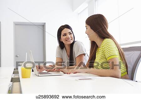 Two Women Working Together In Design Studio View Large Photo Image Stock Image - Two Women Working Together In Design Studio. Fotosearch