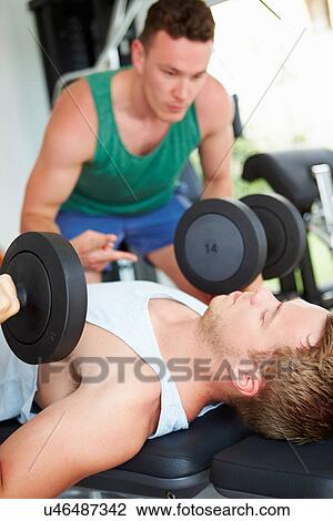 Two Young Men Training In Gym With Weights View Large Photo Image Stock Image - Two Young Men Training In Gym With Weights. Fotosearch