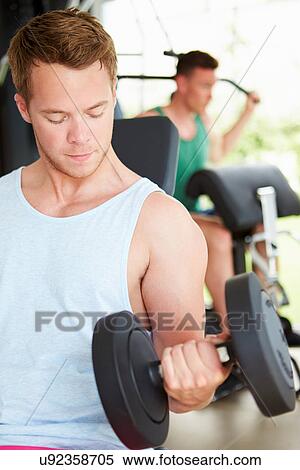 Two Young Men Training In Gym With Weights View Large Photo Image Stock Photography - Two Young Men Training In Gym With Weights. Fotosearch