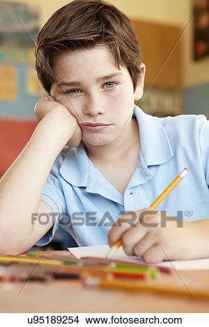 Picture - Unhappy boy in art class. Fotosearch