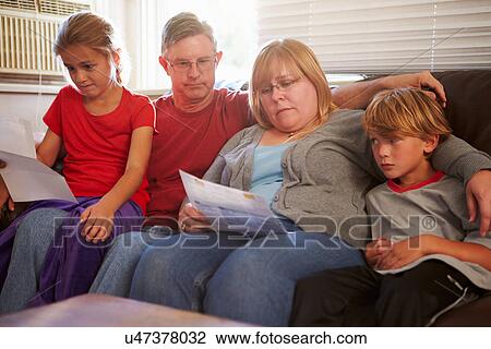Unhappy Family Sitting On Sofa Looking At Bills View Large Photo Image Stock Image - Unhappy Family Sitting On Sofa Looking At Bills. Fotosearch