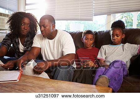 Unhappy Family Sitting On Sofa Looking At Bills View Large Photo Image Stock Photo - Unhappy Family Sitting On Sofa Looking At Bills. Fotosearch