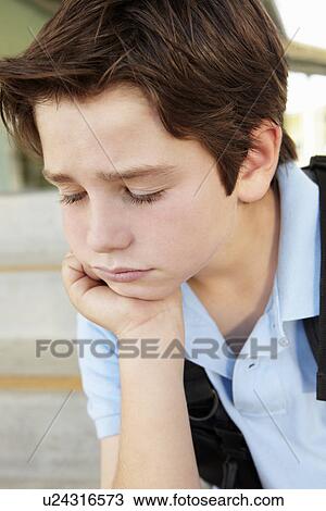Stock Image - Unhappy Pre teen boy at school. Fotosearch