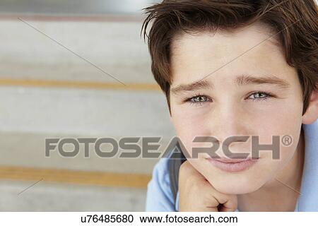 Stock Image - Unhappy Pre teen boy at school. Fotosearch