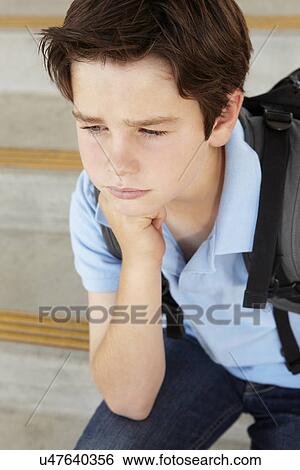 Stock Photograph - Unhappy Pre teen boy at school. Fotosearch