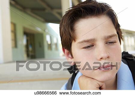 Stock Photograph - Unhappy Pre teen boy at school. Fotosearch