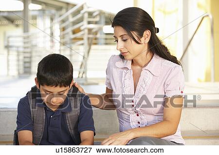 Unhappy Pre teen boy in school View Large Photo Image Stock Photo - Unhappy Pre teen boy in school. Fotosearch