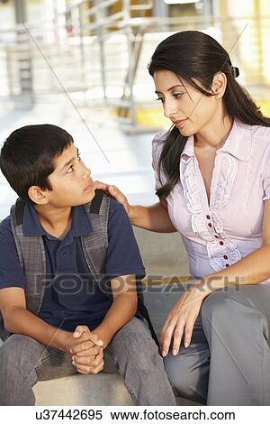 Unhappy Pre teen boy in school View Large Photo Image Stock Photography - Unhappy Pre teen boy in school. Fotosearch