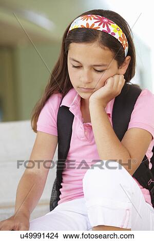 Unhappy Pre teen girl at school View Large Photo Image Picture - Unhappy Pre teen girl at school. Fotosearch
