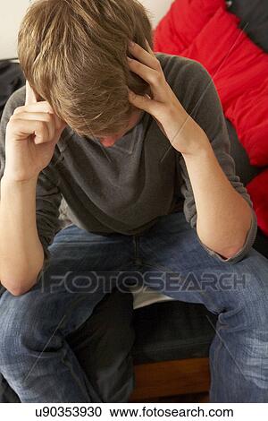 Stock Image - Unhappy teenage boy. Fotosearch