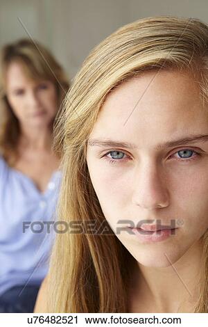 Unhappy teenage girl with mother View Large Photo Image Stock Image - Unhappy teenage girl with mother. Fotosearch