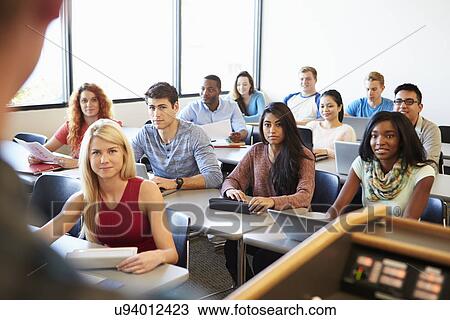 Stock Image - University Students Using Digital Tablet And Laptop In Class. Fotosearch