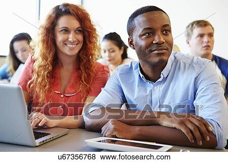 University Students Using Digital Tablet And Laptop In Class View Large Photo Image Stock Photo - University Students Using Digital Tablet And Laptop In Class. Fotosearch