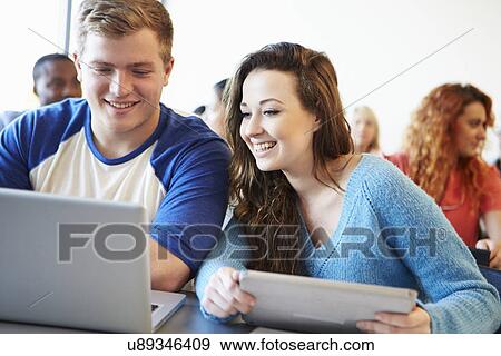Stock Photo - University Students Using Digital Tablet And Laptop In Class. Fotosearch
