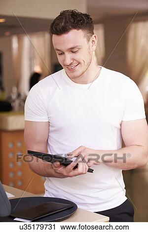 Waiter In Hotel Using Digital Tablet View Large Photo Image Stock Image - Waiter In Hotel Using Digital Tablet. Fotosearch