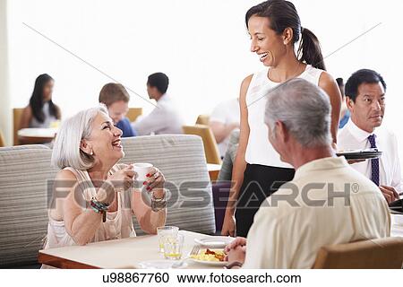 Waitress Serving Senior Couple Breakfast In Hotel Restaurant View Large Photo Image Stock Image - Waitress Serving Senior Couple Breakfast In Hotel Restaurant. Fotosearch