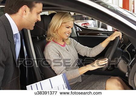 Woman buying new car View Large Photo Image Stock Photo - Woman buying new car. Fotosearch
